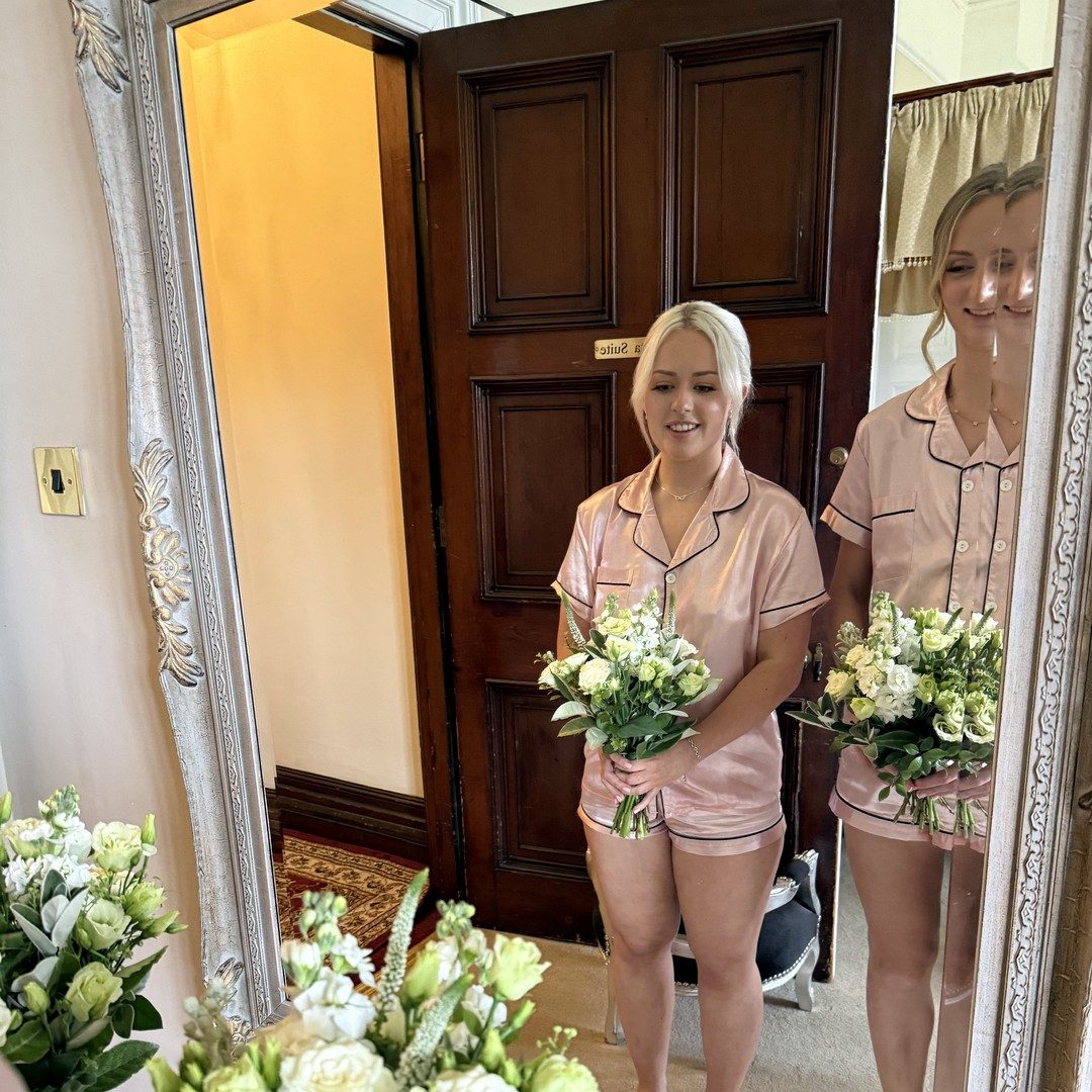 Angie and the team holding hand-tied bouquets in the shop