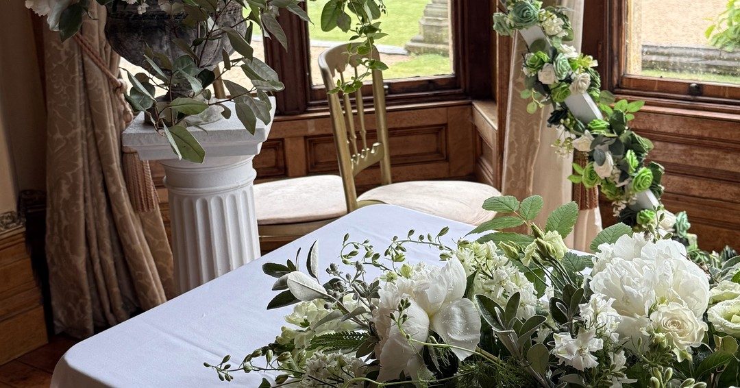 White seasonal wedding flowers styled on a table
